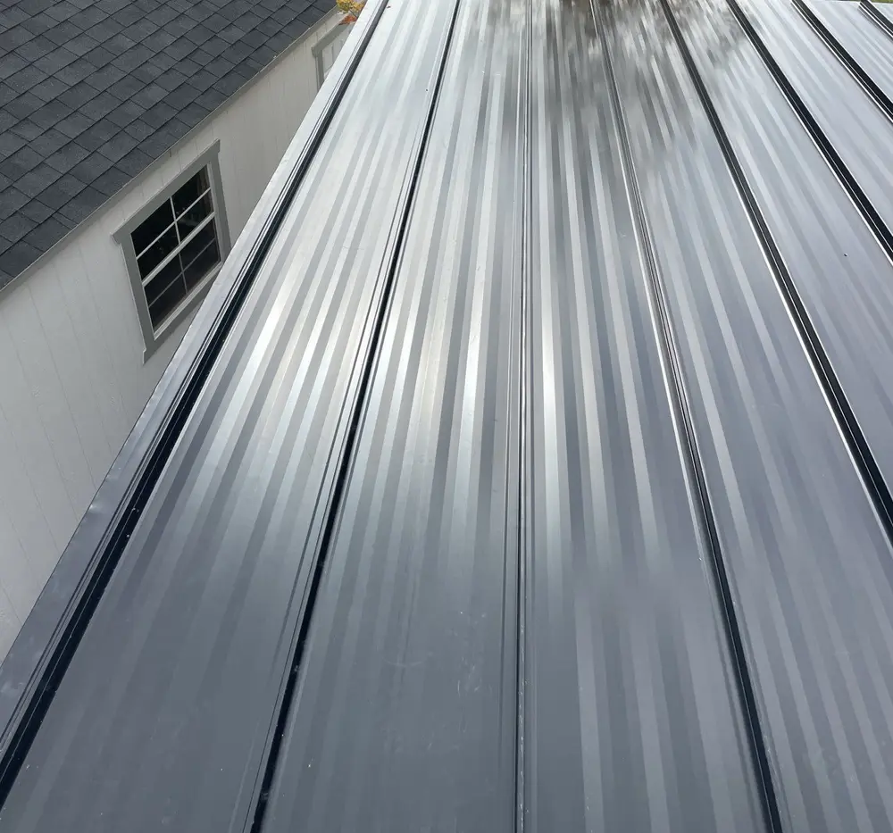 Black metal pergola roof installed by Homer Roofing in North Logan, Utah