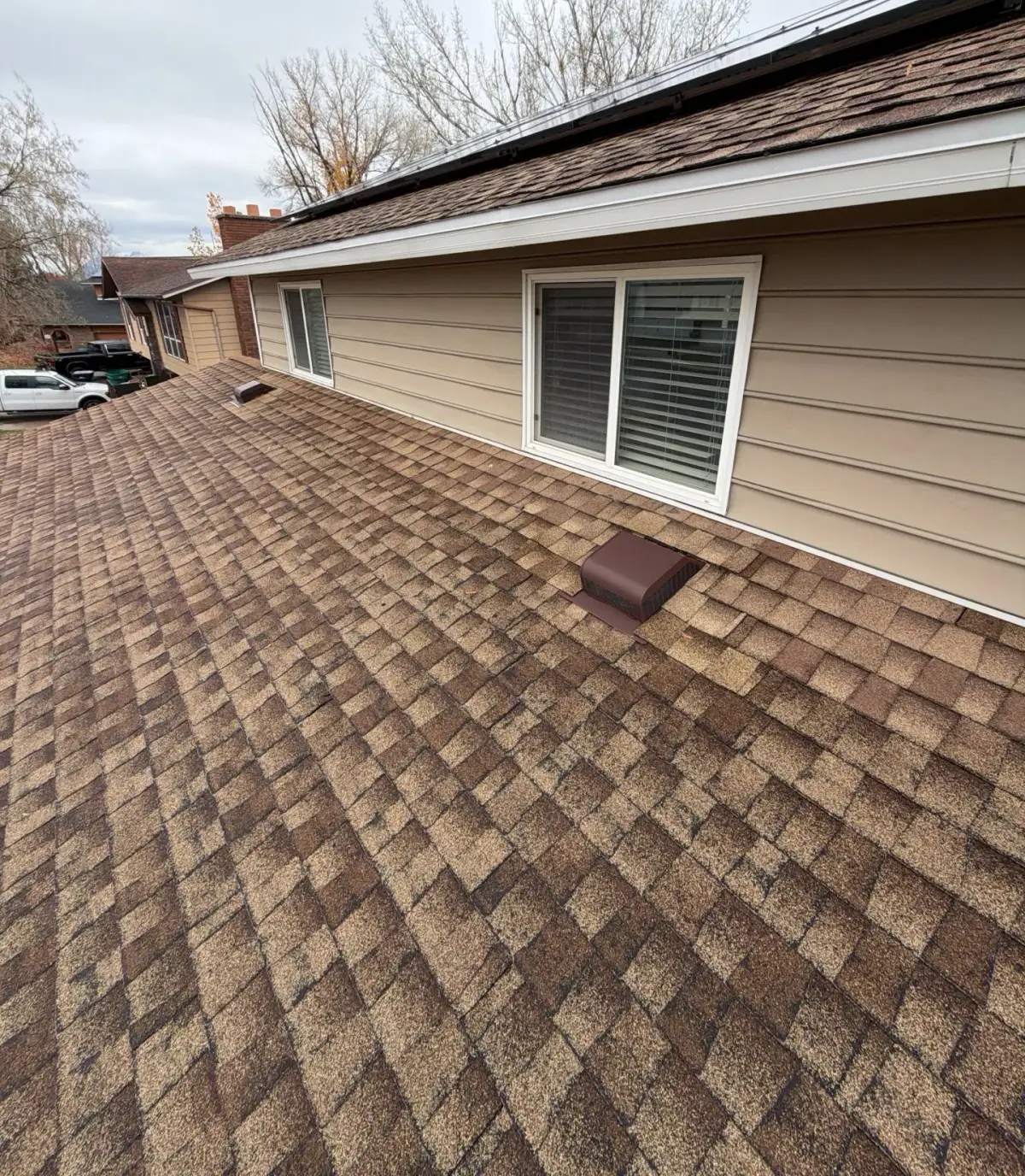 New weathered-wood asphalt shingle roof with attic box vent on a Roy, Utah home by Homer Roofing