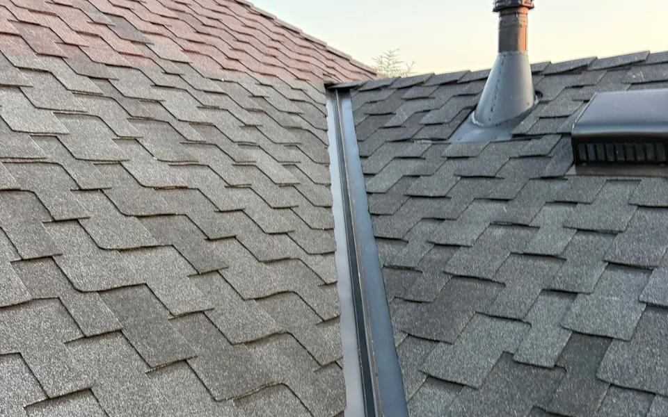 Metal valley flashing where two slopes of a new shingle roof meet