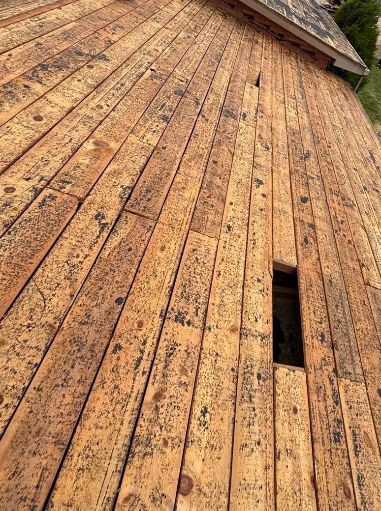 Spaced skip sheathing on a Utah roof viewed from the rooftop during tear-off