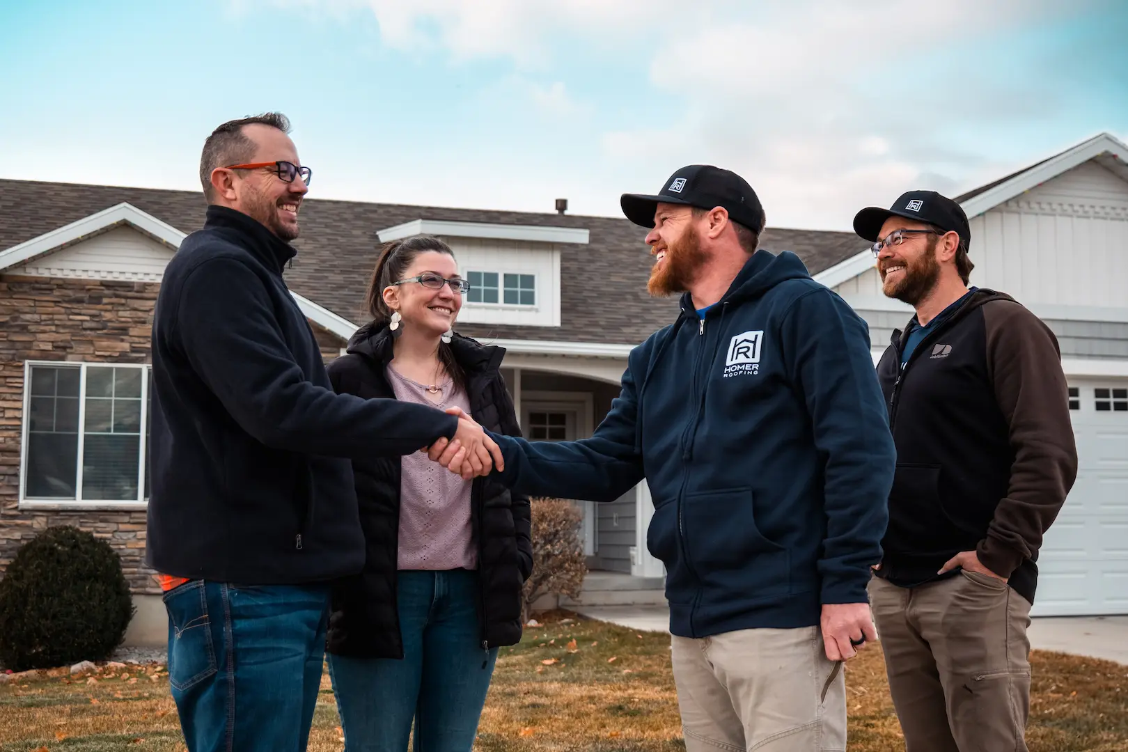 Homer Roofing team meeting with homeowners